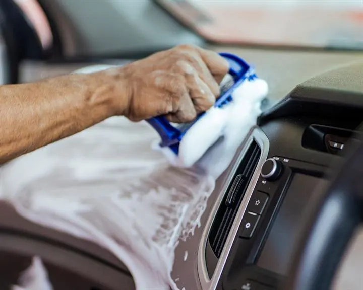 Dashboard being cleaned and treated during interior restoration